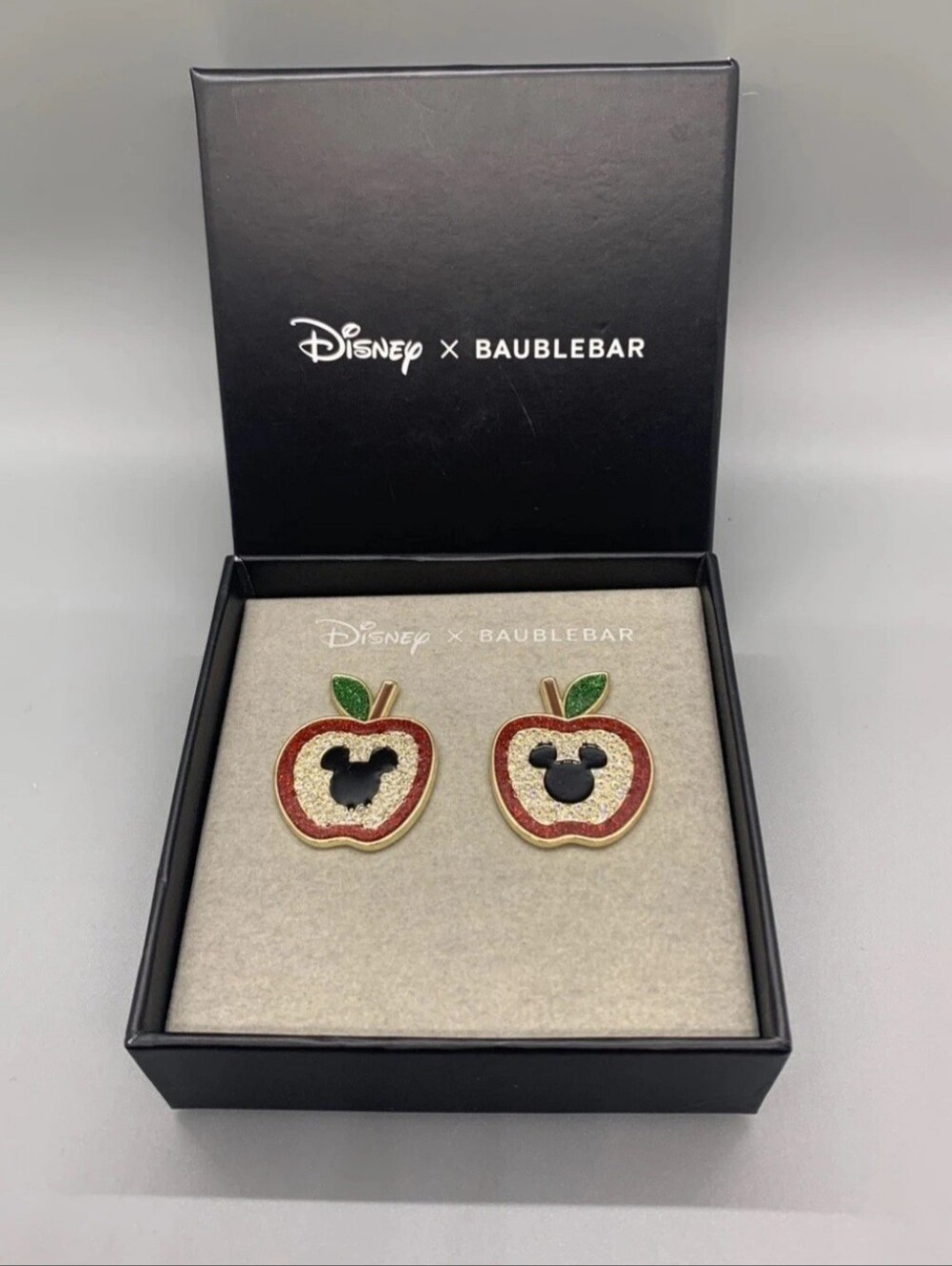 Disney x BaubleBar Mickey Mouse Apple earrings in a branded box
